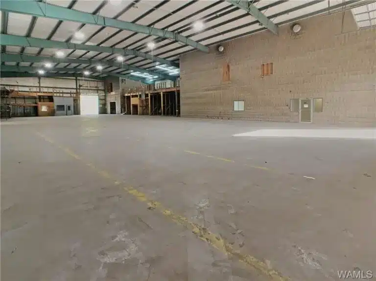 an empty road with a building in the background